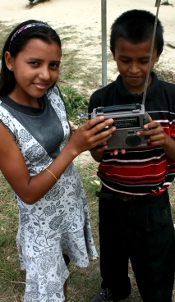 Child holding Freeplay solar shortwave radio